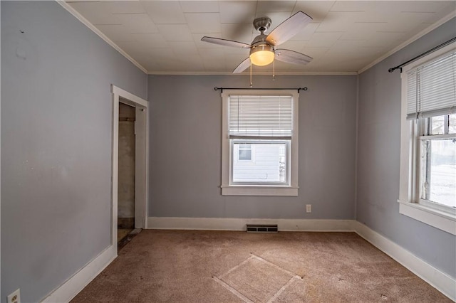 carpeted empty room with ornamental molding and ceiling fan