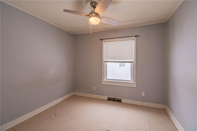 spare room featuring carpet flooring and ceiling fan