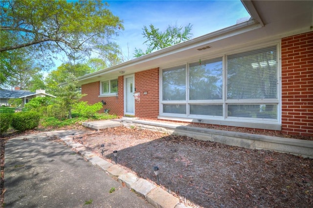 property entrance with brick siding