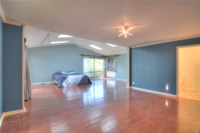 unfurnished bedroom with baseboards, ornamental molding, lofted ceiling with skylight, and wood finished floors