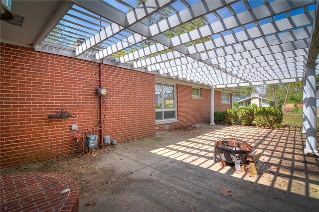 view of patio / terrace featuring an outdoor fire pit and visible vents