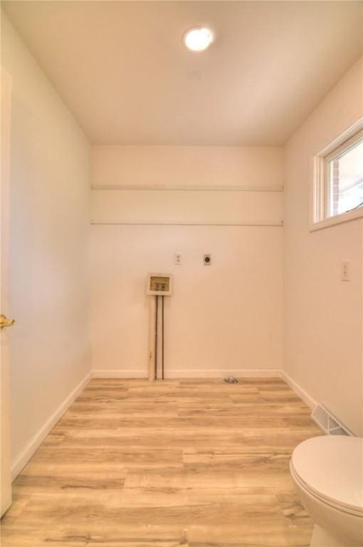 clothes washing area featuring laundry area, baseboards, light wood-type flooring, recessed lighting, and hookup for an electric dryer