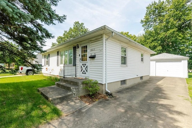 2417 Maple Ave, Decatur, IL 62526 - ranch-style home featuring an outbuilding, a detached garage, a front lawn, and concrete driveway