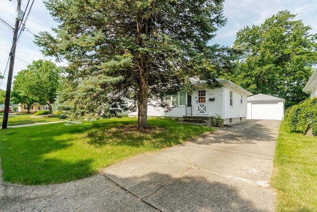 2417 Maple Ave, Decatur, IL 62526 - view of front of home featuring an outdoor structure, a front yard, a detached garage, and concrete driveway