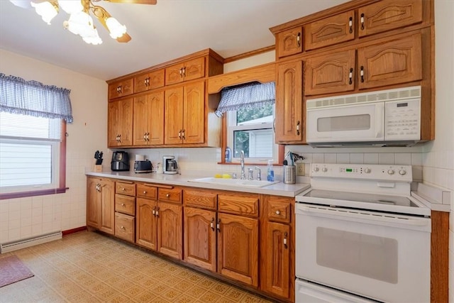 2417 Maple Ave, Decatur, IL 62526 - kitchen featuring white appliances, brown cabinetry, a baseboard heating unit, light countertops, and tasteful backsplash