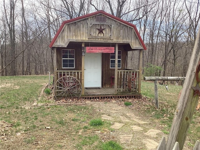 view of outbuilding with a view of trees and an outdoor structure