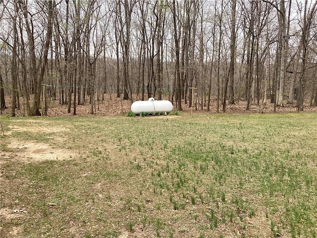 view of yard with a view of trees