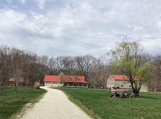 surrounding community featuring driveway and a lawn