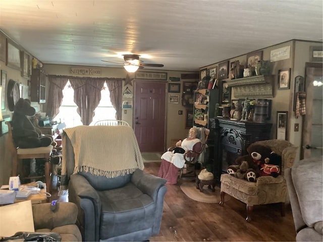 living area featuring a ceiling fan and wood finished floors