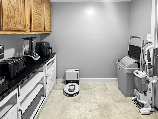 kitchen featuring brown cabinetry and baseboards