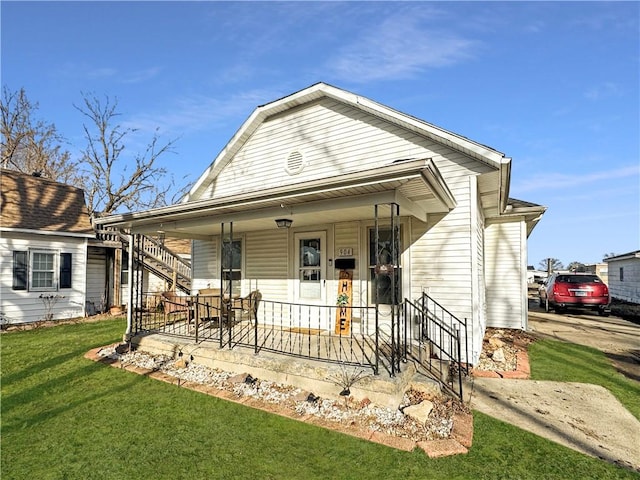 view of front of home with covered porch and a front yard