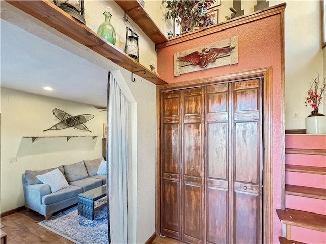 interior space featuring wood finished floors and baseboards