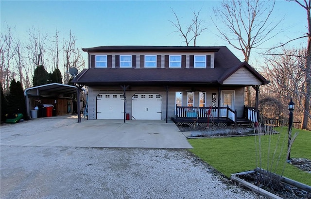 view of front of property featuring a porch, concrete driveway, a garage, a front yard, and a carport