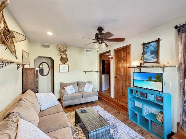 living area with recessed lighting, visible vents, ceiling fan, and wood finished floors