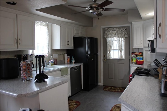 kitchen featuring white cabinetry, backsplash, a healthy amount of sunlight, and black dishwasher