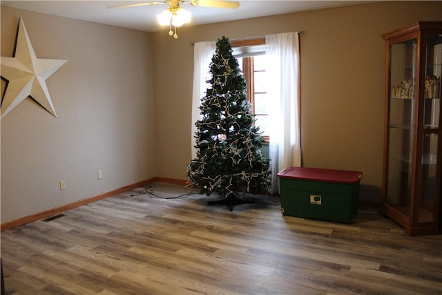 empty room with dark wood-type flooring and ceiling fan