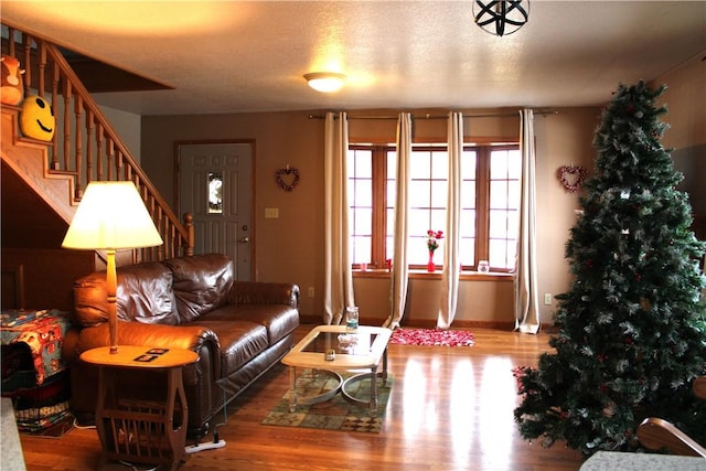 living room with wood-type flooring and a textured ceiling