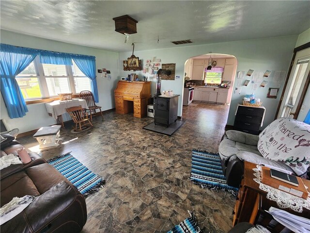 17204 N 125th St, Oblong, IL 62449 - living area with arched walkways, dark stone finish floors, and a wood stove