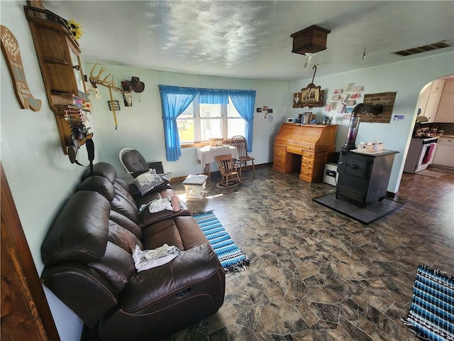 17204 N 125th St, Oblong, IL 62449 - living area with arched walkways, dark stone finish flooring, and a wood stove