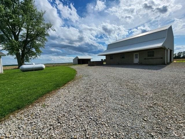 17204 N 125th St, Oblong, IL 62449 - view of property exterior featuring an outdoor structure and gravel driveway