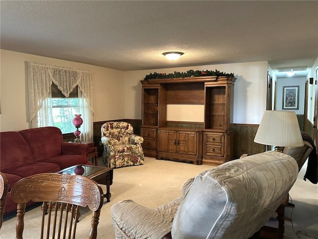 601 Holiday Dr, Effingham, IL 62401 - living room featuring wainscoting, light colored carpet, wood walls, and a textured ceiling