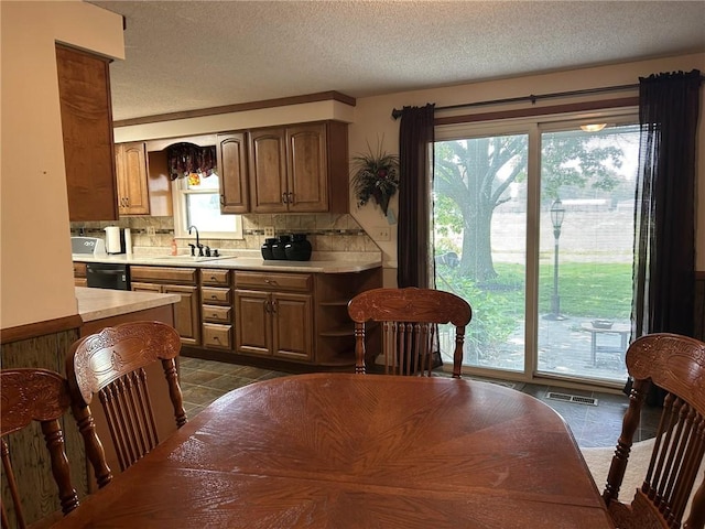 601 Holiday Dr, Effingham, IL 62401 - kitchen featuring light countertops, backsplash, dishwashing machine, a textured ceiling, and open shelves