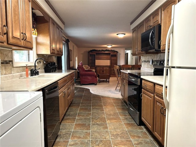 601 Holiday Dr, Effingham, IL 62401 - kitchen with black appliances, tasteful backsplash, light countertops, open floor plan, and dark stone finish flooring