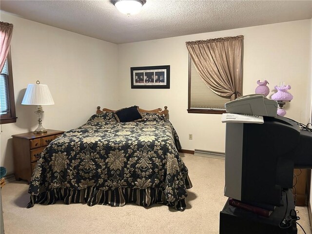 601 Holiday Dr, Effingham, IL 62401 - bedroom with carpet floors, a textured ceiling, and a baseboard radiator
