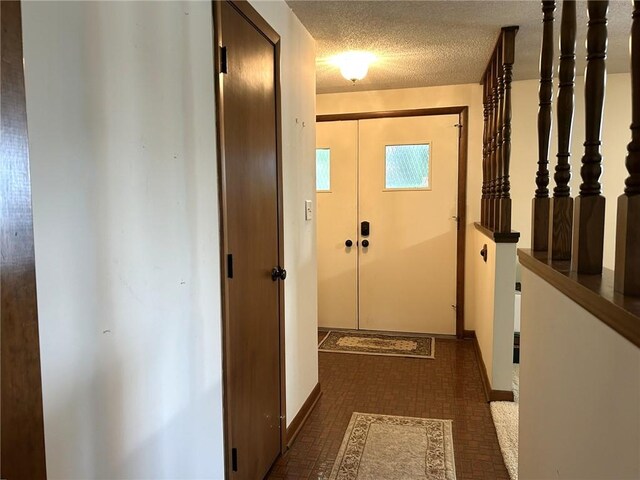 601 Holiday Dr, Effingham, IL 62401 - doorway with brick patterned floors and a textured ceiling