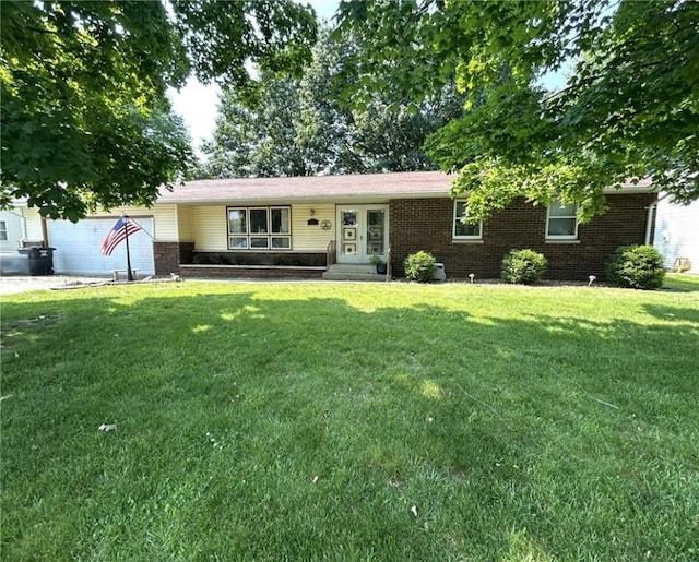 601 Holiday Dr, Effingham, IL 62401 - ranch-style house with brick siding, a front lawn, and a garage