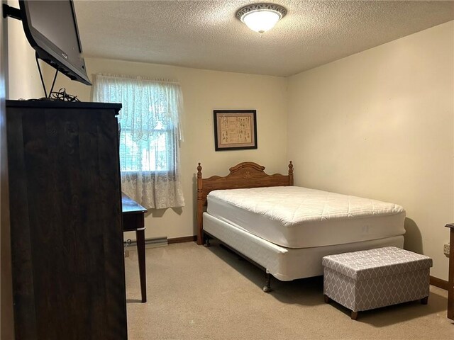 601 Holiday Dr, Effingham, IL 62401 - bedroom featuring light carpet and a textured ceiling