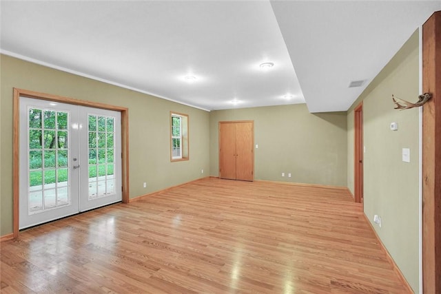 9092 N County Road 2150 E, Ashmore, IL 61912 - spare room featuring light wood-style floors, french doors, and baseboards