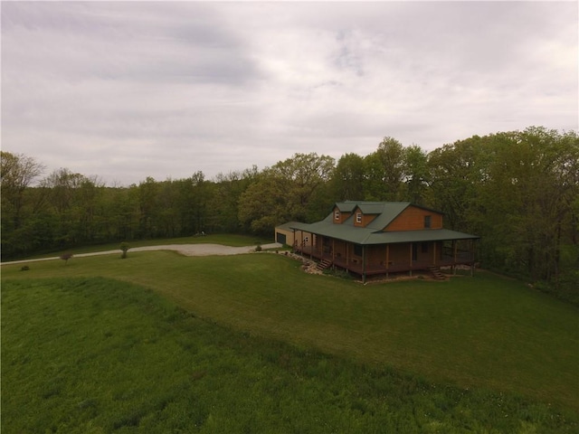 9092 N County Road 2150 E, Ashmore, IL 61912 - view of grassy yard with a view of trees, a porch, and driveway