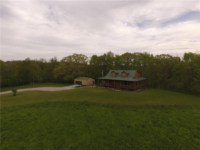 9092 N County Road 2150 E, Ashmore, IL 61912 - view of green lawn featuring driveway, a garage, a view of trees, and an outdoor structure