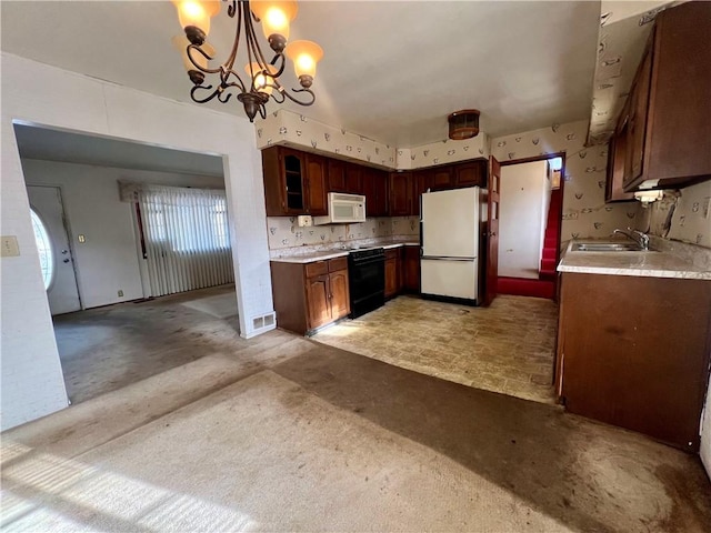 kitchen featuring sink, a chandelier, light colored carpet, pendant lighting, and white appliances