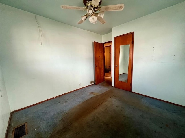 spare room with ceiling fan and carpet