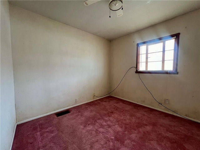 empty room featuring ceiling fan and carpet floors