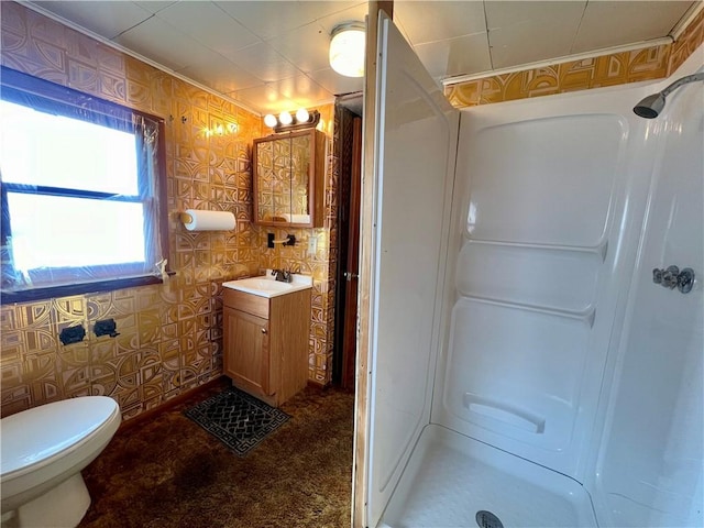 bathroom featuring walk in shower, ornamental molding, toilet, and vanity