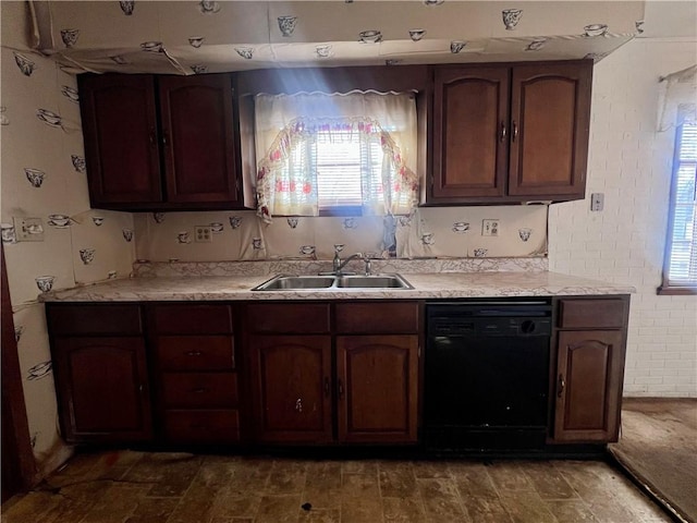 kitchen featuring dark brown cabinetry, sink, and dishwasher