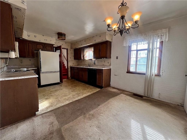 kitchen featuring pendant lighting, dishwasher, white fridge, dark brown cabinetry, and light carpet