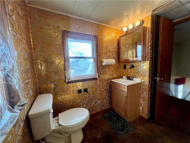 bathroom with ornamental molding, vanity, and toilet