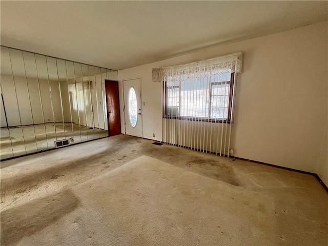 foyer entrance with light carpet