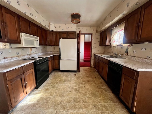 kitchen with sink and black appliances