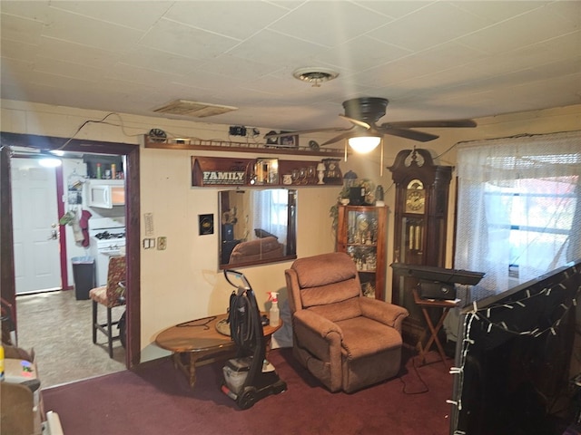 living room featuring carpet, ceiling fan, and a healthy amount of sunlight