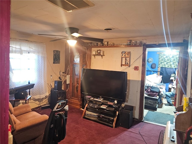 carpeted living room with ceiling fan