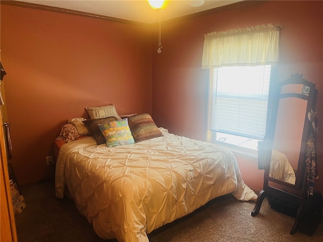 bedroom with carpet, ceiling fan, and ornamental molding