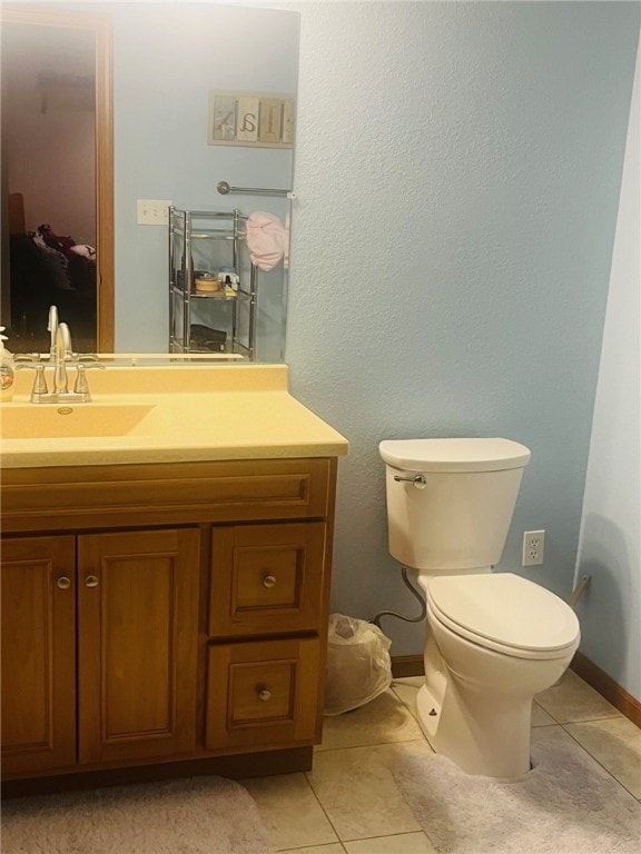 bathroom featuring tile patterned floors, vanity, and toilet