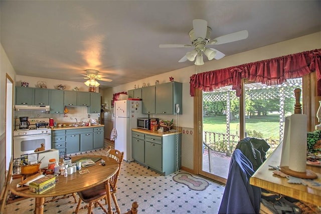 4111 Dye Rd, Illiopolis, IL 62539 - kitchen with white appliances, green cabinets, ceiling fan, under cabinet range hood, and light countertops