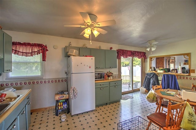 4111 Dye Rd, Illiopolis, IL 62539 - kitchen featuring freestanding refrigerator, green cabinets, ceiling fan, stainless steel microwave, and light flooring