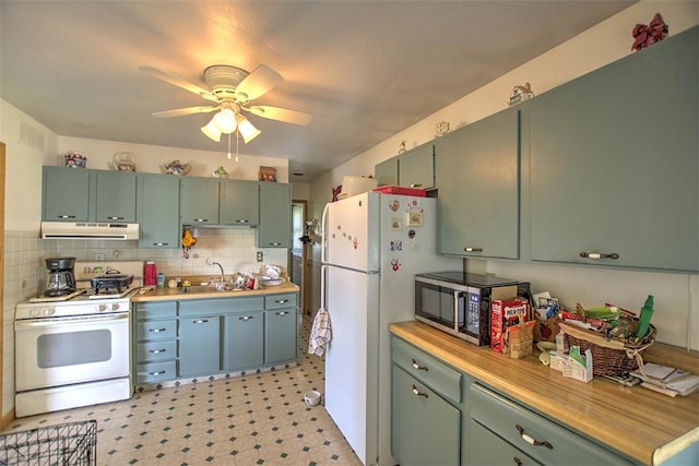 4111 Dye Rd, Illiopolis, IL 62539 - kitchen with white appliances, under cabinet range hood, green cabinets, and ceiling fan